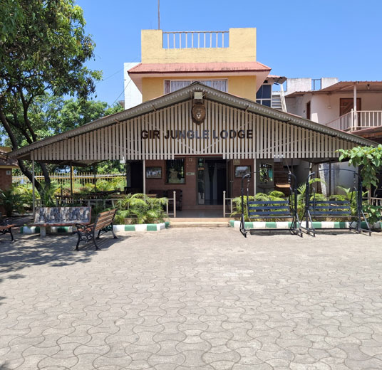 Gir Jungle Lodge – Luxury Resort exterior surrounded by lush forest near Gir National Park